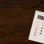 flat-lay-desk-february-calendar-copy-space-min