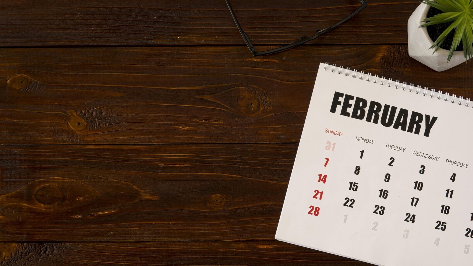 flat-lay-desk-february-calendar-copy-space-min